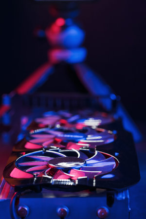 A graphics card with a row of fans with a cyanotic purple backlight in a futuristic design. Powerful...