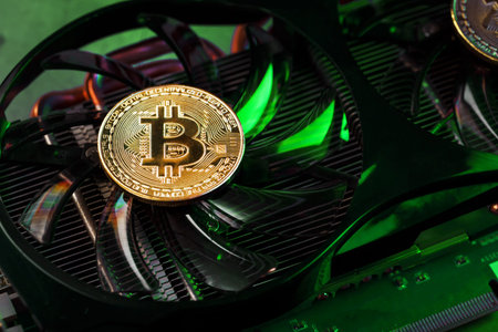 Gold bitcoin on the video card cooler with green neon lighting in the Cyberpunk style. The concept...