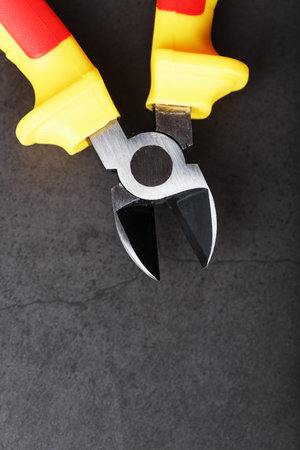 The pliers tool is red on a black background with a free space. Top view