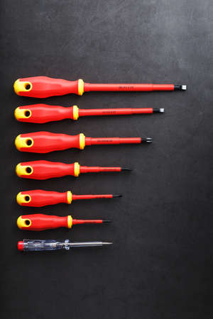 The tool is red screwdrivers in a row on a black background with a free space. Top viewの写真素材
