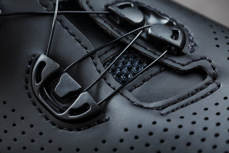 Part of Shoes made of black perforated leather close-up. Macro