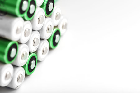 Pyramids of AA batteries on a white background with free space. The concept of energy supply and...