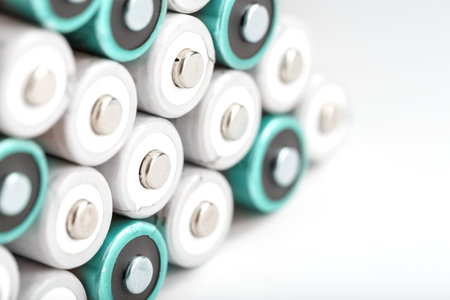 Batteries and AAA batteries are a pyramid on a white background with free space. The concept of...