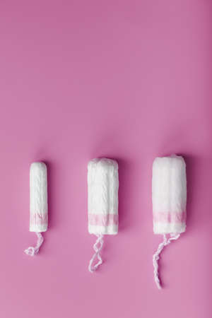 Cotton tampons on a pink background with a free space. Top view, flat surface.の写真素材