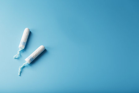 Gynecological tampons on a blue background, free space