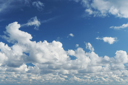 Blue sky with cumulus clouds over the sea in full screen