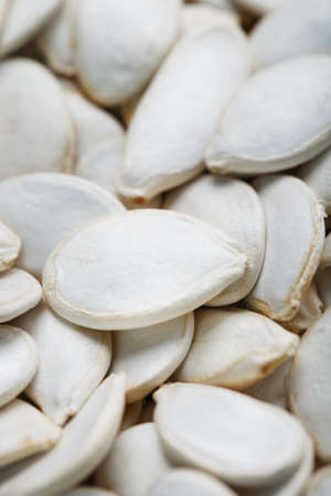 Pumpkin seeds in a shell close-up, macro as a background. full screen super food from parasitesの写真素材