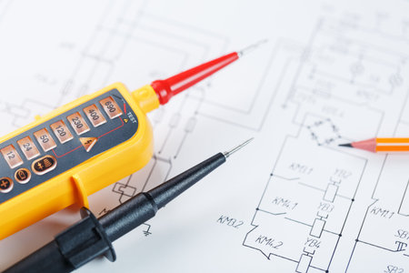 The two-pole voltage indicator lies on the electrical drawing. Testing and verification of power...
