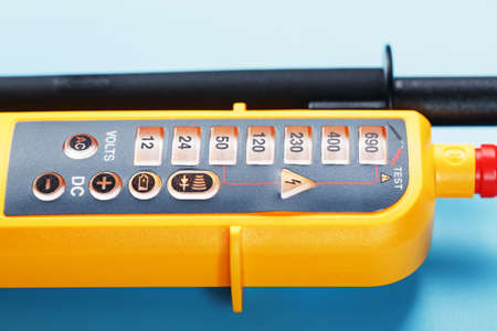 Yellow voltage indicator on a blue background. Free space Testing and verification of electrical networksの写真素材