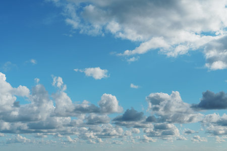 Blue sky with cumulus clouds over the sea in full screen