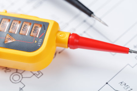 Yellow voltage indicator in close-up on the electrical diagram. Testing and verification of power...