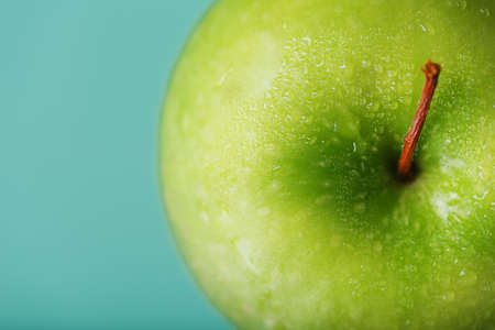 Juicy Green apple on a green background with a minimalistic composition. Macroの写真素材