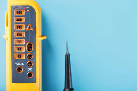 Yellow voltage indicator on a blue background. Free space Testing and verification of electrical networksの写真素材