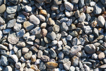 The texture of coarse gravel in full screen as a background. View from above