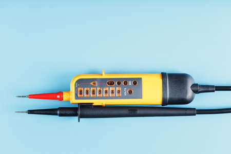 Yellow voltage indicator on a blue background. Free space Testing and verification of electrical networksの写真素材