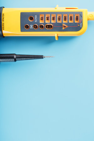 Two-pole voltage indicator close-up on a blue background. Testing and verification of electrical...