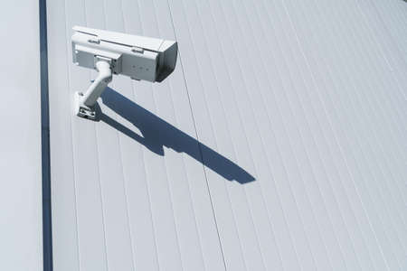 CCTV camera on the wall of the building for monitoring and protection. Total security control system concept.の写真素材