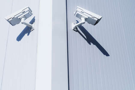 CCTV camera on the wall of the building for monitoring and protection. Total security control system concept.の写真素材