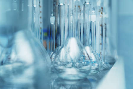 Laboratory flasks in a row on a shelf in the laboratory. Science and Medicineの写真素材