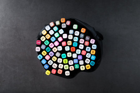 A set of markers for drawing in different colors for sketching with markings in a bag on a black...