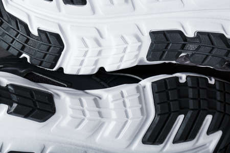 The black and white sole of trendy sports sneakers is a close-up in full screen.の写真素材