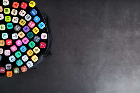 Professional sketching markers of different colors in a bag on a dark table. Free spaceの写真素材