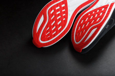 Close-up of the sole of a sport running shoe for running in red Sports technology