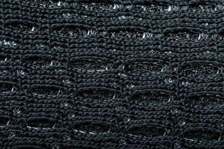 Mesh of black sports sneakers for training close-up in full screen