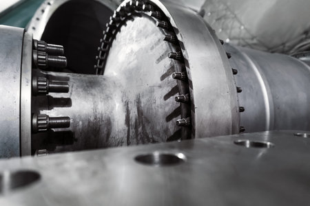 The rotor of a gas turbine compressor with a bolted coupling half. Internal elements of the...
