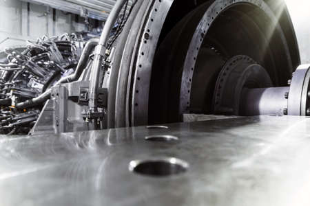 A gas turbine with a compressor rotor and a bolted coupling half. Internal elements of the disassembled turbineの写真素材