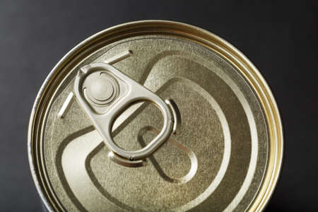 A can with a metal lid and a ring for opening. top viewの写真素材