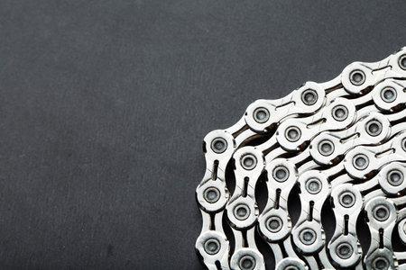 Shiny mountain bike chain on dark background with free space