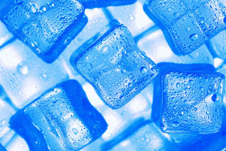 Ice cubes with blue backlight in the freezer close-up in full screen selective focusの写真素材