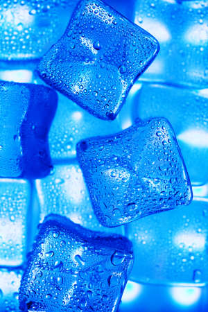 Ice cubes with blue backlight in the freezer close-up in full screenの写真素材