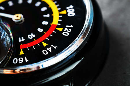 Hand air pump manometer for pressure control on a dark background close-upの写真素材