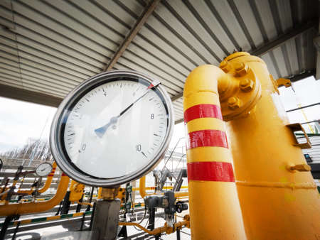 Yellow gas pipeline with a large pressure gauge for measuring gas pressureの写真素材