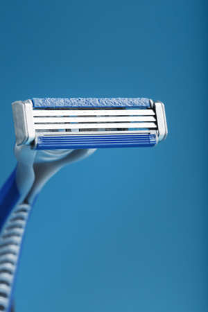 Blades of a new shaving machine on a blue background close-up free spaceの写真素材