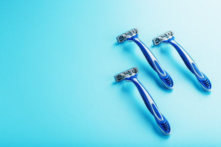 Blue shaving machine with sharp blades on the background of ice cubes close-up. The concept of cleanliness and frosty freshnessの写真素材