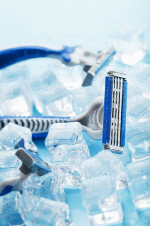 Three shaving machines on a frosty blue background with ice. The concept of cleanliness and frosty...