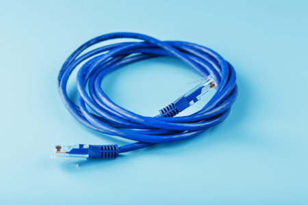 Blue Ethernet Cable Cord Patch cord on a blue background with free spaceの写真素材
