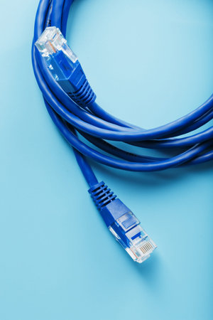 Two Ethernet Cable Connectors Patch cord cord close-up isolated on a blue background with free space