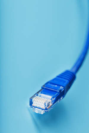 Cable connector Patch cord cord close-up on a blue background with free spaceの写真素材