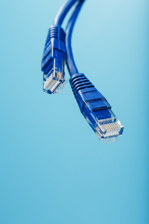 Blue Cable Cord Patch cord on a blue background with free spaceの写真素材