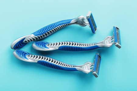 Blue shaving machines in a row on a blue backgroundの写真素材
