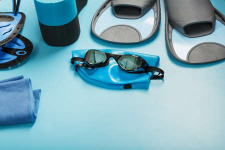 Sports equipment for swimming in the pool and open water on a blue backgroundの写真素材