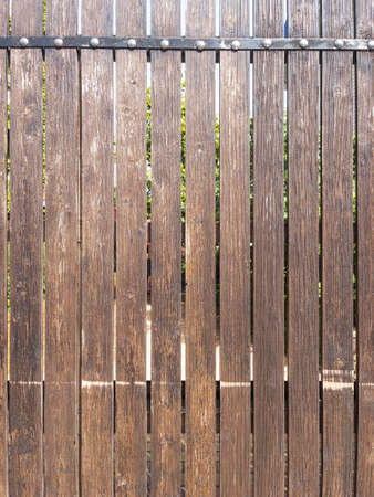 Fence made of vertical boards of natural woodの写真素材
