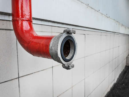 Red fire-fighting pipeline with a close-up lockの写真素材