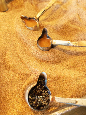Preparation of natural coffee in Turks on the sand.の写真素材