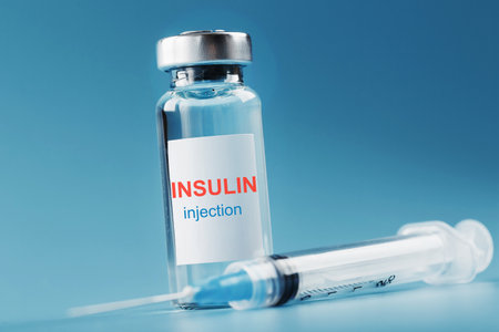 A bottle of insulin hormone and a syringe on the tableの写真素材