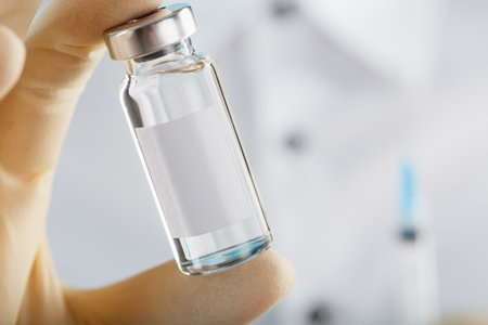 The doctor holds a syringe for injections and an ampoule with insulin for the treatment of Diabetesの写真素材